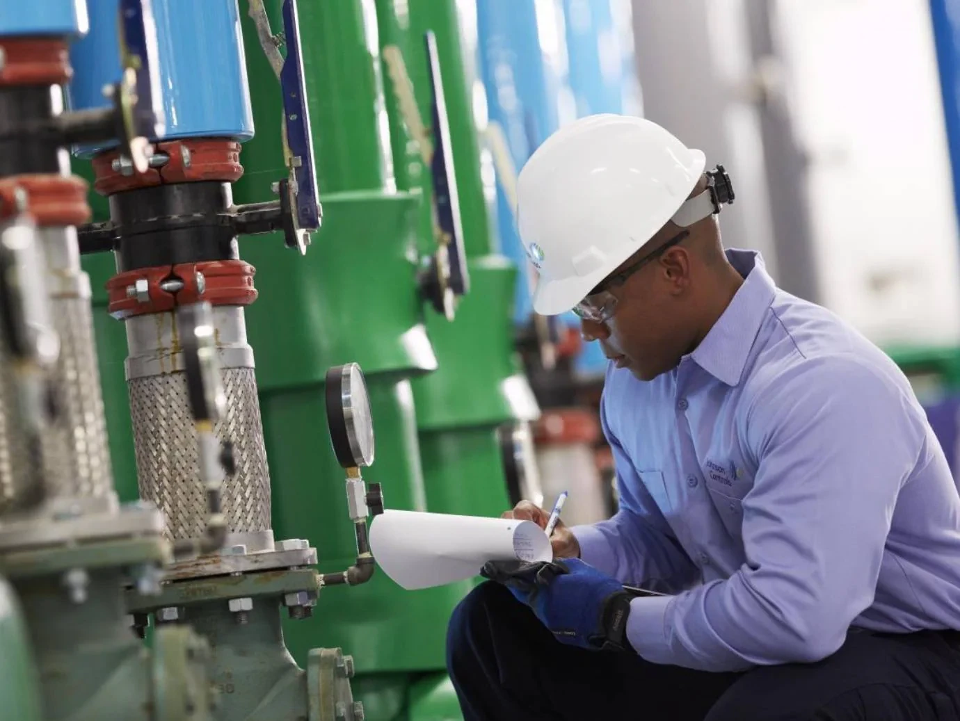 HVAC professional noting equipment readings during a mechanical system inspection